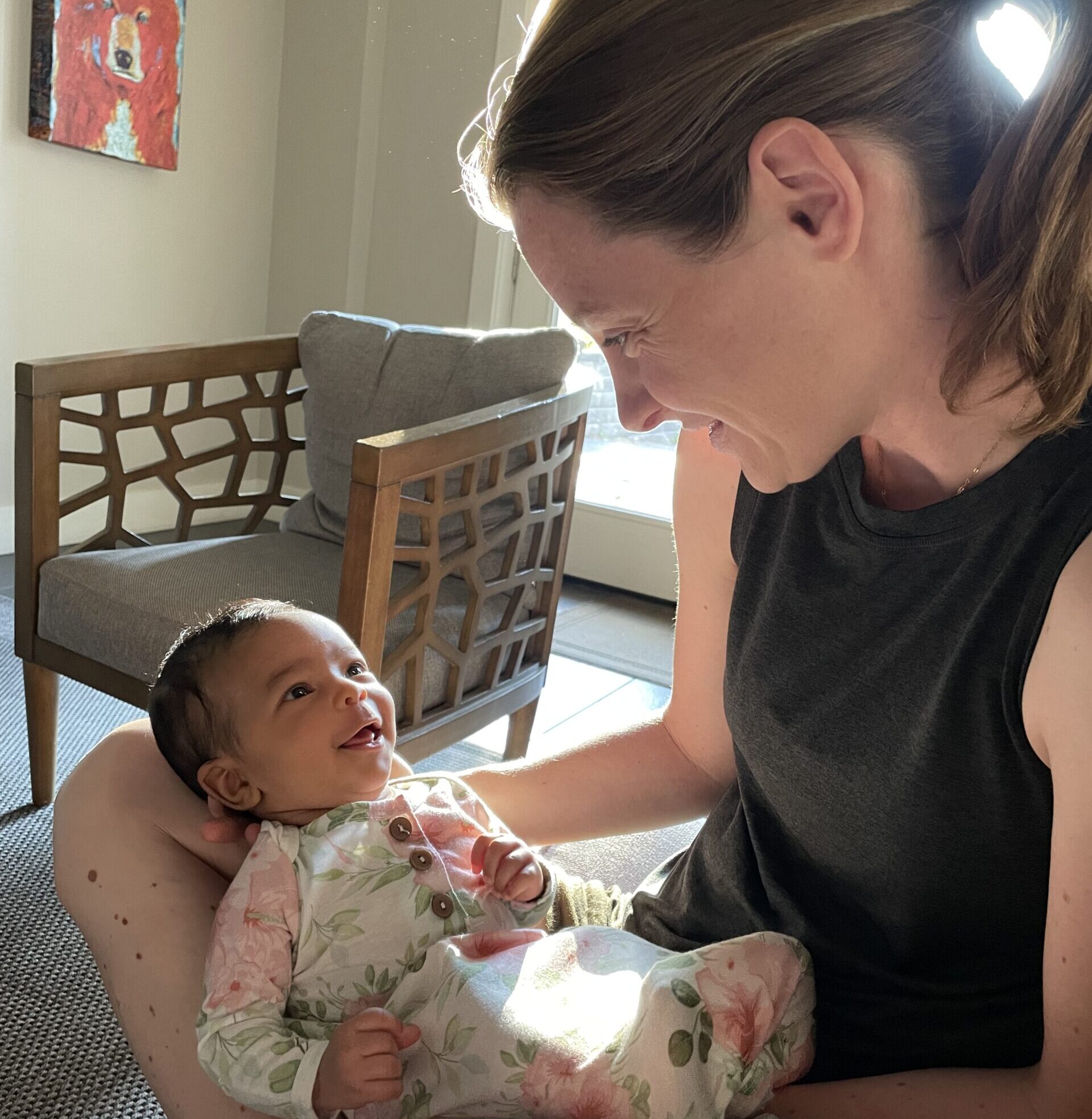 mother looking at infant, both smiling